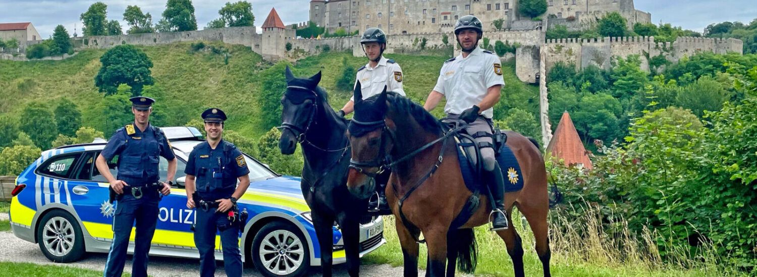Zwei berittene Polizisten und zwei Polizisten mit Streifenwagen mit Bugpanorama © Stadt Burghausen