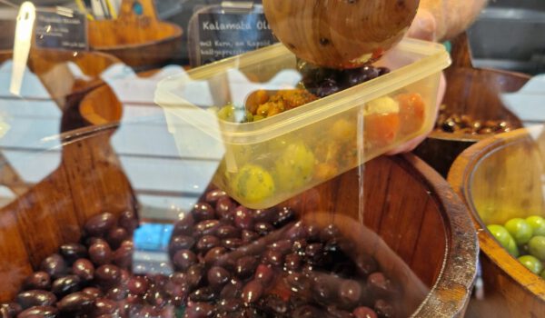 Burghauser Wochenmarkt: Verkäufer füllt Oliven in ein mitgebrachtes Gefäß einer Kundin © Stadt Burghausen/ebh