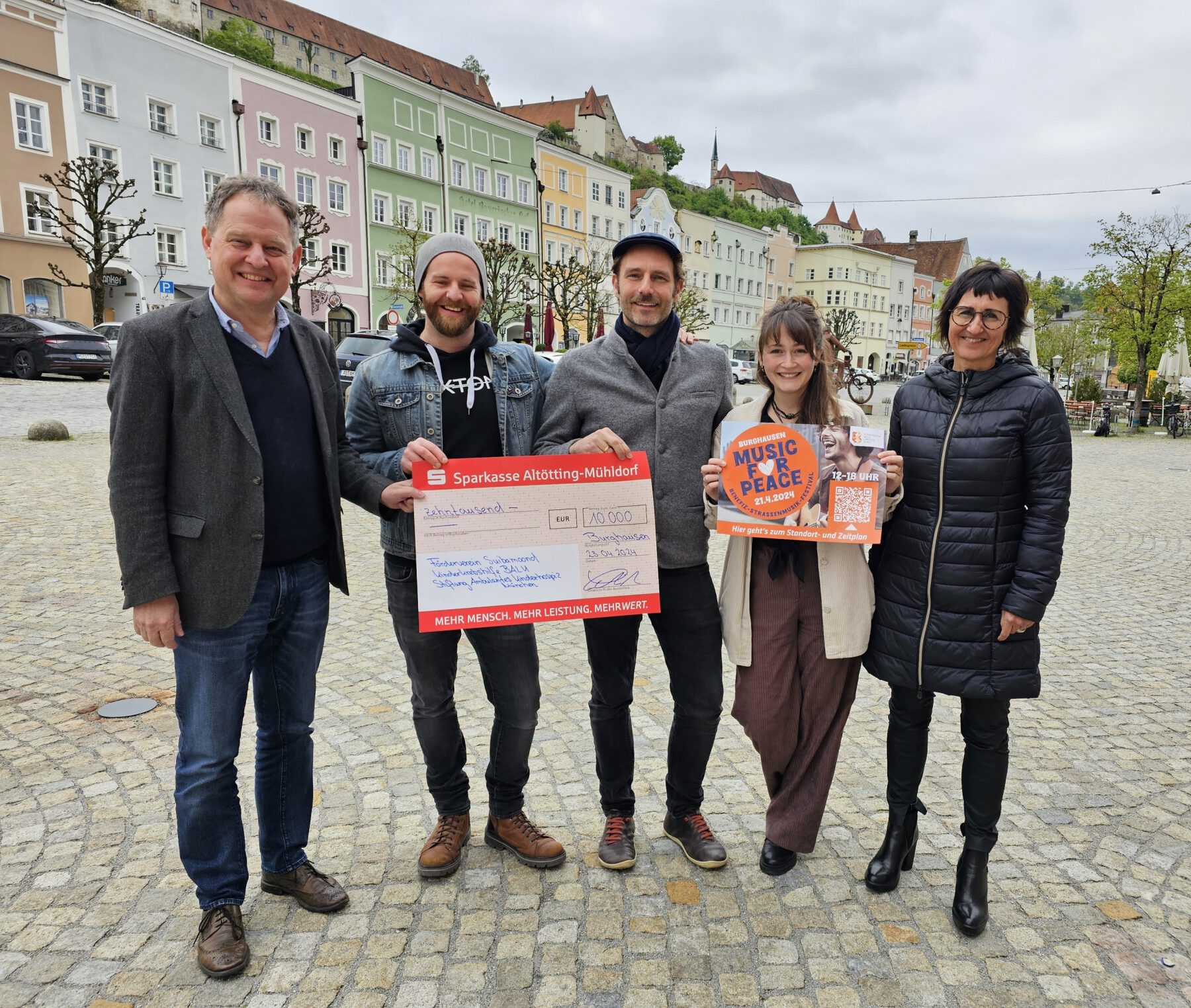 The organizers of the charity street music festival happily accepted the donation amount, which had been increased to €10.000 by the city. From left: First Mayor Florian Schneider, the organizers Max Roxton, Erik Bönisch, Susanne Kramlinger and Sigrid Resch, managing director of Burghauser Touristik GmbH. Photo credit: City of Burghausen